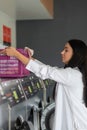 Young woman doing his weekly washing in a laundromat. Royalty Free Stock Photo