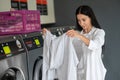 Young woman doing his weekly washing in a laundromat. Royalty Free Stock Photo