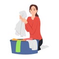 Young woman doing housework chores sorting dirty laundry in clothes basin Royalty Free Stock Photo