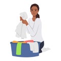 Young woman doing housework chores sorting dirty laundry in clothes basin Royalty Free Stock Photo