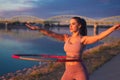 Young woman doing hula hoop exercise at riverside Royalty Free Stock Photo