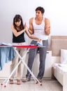 Young woman doing ironing for her husband Royalty Free Stock Photo