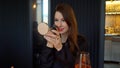 Young woman doing make up. Girl with red lipstick applies powder with brush. Royalty Free Stock Photo