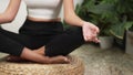 Young woman doing morning yoga and meditation in her bedroom. Blithe