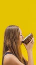 Young woman doing oil pulling over yellow background VERTICAL FORMAT for Instagram mobile story or stories size. Mobile Royalty Free Stock Photo