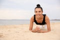 Young woman doing plank exercise on beach, space for text. Body training Royalty Free Stock Photo