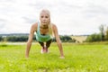 Young woman doing push-ups in the park Royalty Free Stock Photo