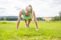 Young woman doing push-ups in the park Royalty Free Stock Photo