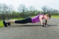 Young woman doing push ups . Royalty Free Stock Photo