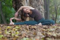 young woman doing revolved seated angle yoga pose