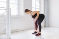 Young woman doing rower resistance exercises