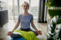 Woman doing some meditation exercise at home