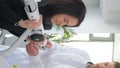 A young woman is doing a spinal examination in a diagnostic machine with a physiotherapist.