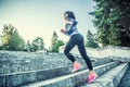 Young woman doing sports and running up the stairs Royalty Free Stock Photo