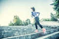 Young woman doing sports and running up the stairs Royalty Free Stock Photo