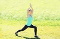 Young woman doing stretching exercises on grass in summer Royalty Free Stock Photo