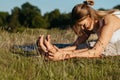 Young Woman Doing Stretching Outdoors on the Grass Royalty Free Stock Photo
