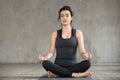 Young woman doing Sukhasana exercise, close up