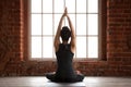 Young woman doing Sukhasana exercise, rear view Royalty Free Stock Photo