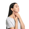 Young woman doing thyroid self examination on white background