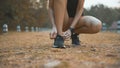 young woman is doing Tie shoelaces before running in nature outdoor Royalty Free Stock Photo