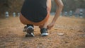 young woman is doing Tie shoelaces before running in nature outdoor Royalty Free Stock Photo