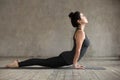 Young woman doing upward facing dog exercise Royalty Free Stock Photo