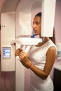 Young woman doing x-ray of teeth on x-ray machine. Royalty Free Stock Photo
