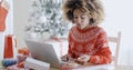 Young woman doing Xmas shopping online Royalty Free Stock Photo