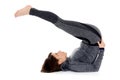 Young woman doing yoga asana Halasana Plow pose