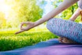 young woman doing yoga asana in park. girl stretching exercise in yoga position. happy and healthy woman sitting in Royalty Free Stock Photo