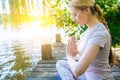 young woman doing yoga asana in park. girl stretching exercise in yoga position. happy and healthy woman sitting in Royalty Free Stock Photo