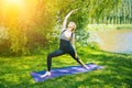 young woman doing yoga asana in park. girl stretching exercise in yoga position. happy and healthy woman sitting in Royalty Free Stock Photo