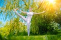 young woman doing yoga asana in park. girl stretching exercise in yoga position. happy and healthy woman sitting in Royalty Free Stock Photo