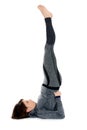 Young woman doing yoga asana Sarvangasana Shoulderstand