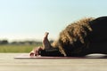 Woman doing yoga exercise away from city life Royalty Free Stock Photo