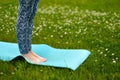 Young woman doing yoga exercise on green grass. face is not visible. Royalty Free Stock Photo