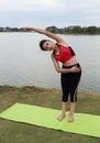 Young woman doing yoga exercise in park
