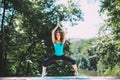 Young woman doing yoga exercise in park. Royalty Free Stock Photo