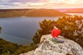 Young woman is doing yoga exercises on the rock above beautiful river. Royalty Free Stock Photo