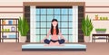 Young woman doing yoga exercises smiling sport fitness girl sitting lotus pose meditation relaxation concept modern gym