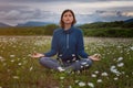 A young woman doing yoga in the field