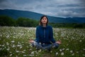 A young woman doing yoga in the field