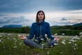 A young woman doing yoga in the field