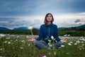 A young woman doing yoga in the field