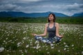 A young woman doing yoga in the field