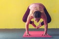 Young woman doing yoga handstand pose in class Royalty Free Stock Photo