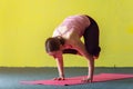 Young woman doing yoga handstand pose in class Royalty Free Stock Photo