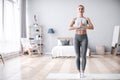 Young woman doing yoga at home, tree pose Royalty Free Stock Photo