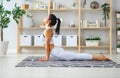 Woman doing yoga, meditating in Lotus position at home Royalty Free Stock Photo